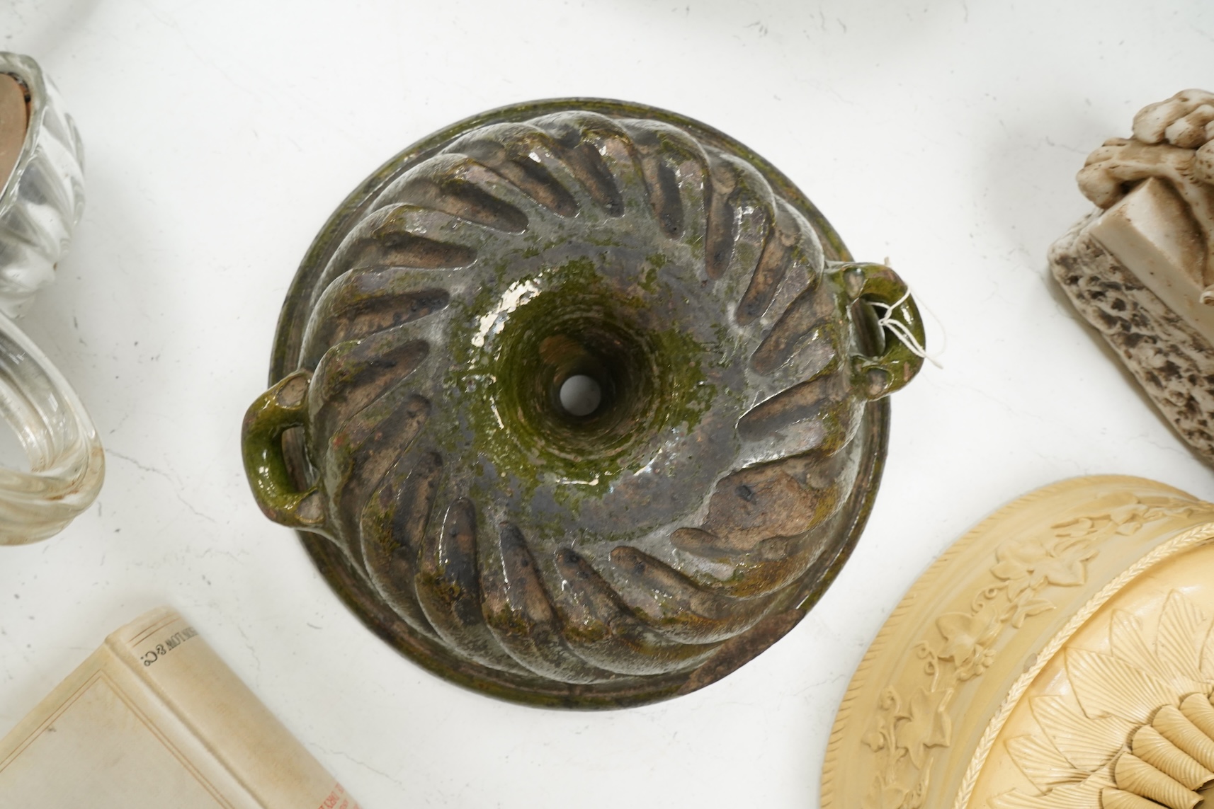A 19th century oval caneware game/pie dish and cover, 24cm wide with an antique cake mould, (2)